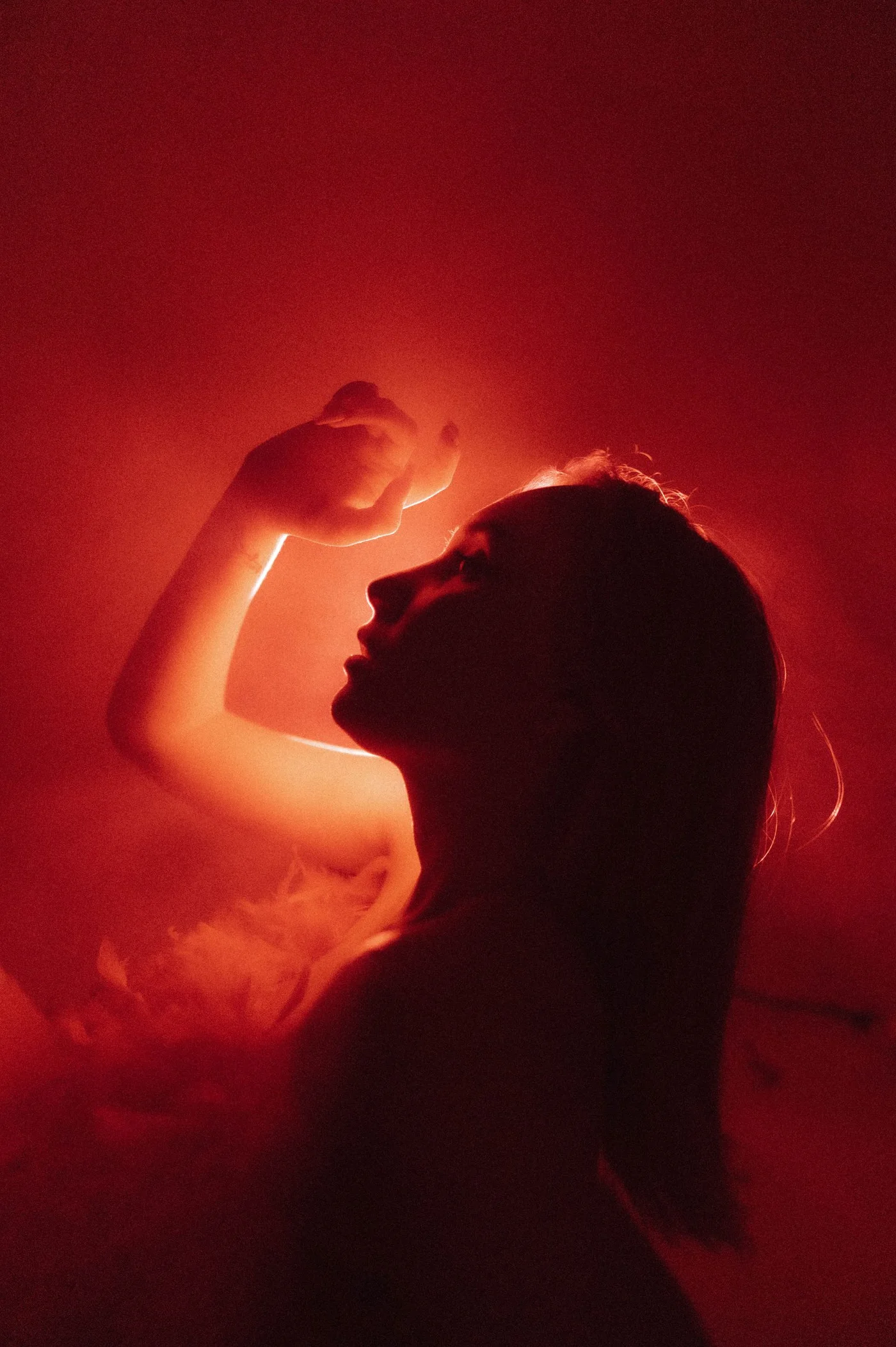 Editorial red-lit portrait by Jayson Hinrichsen